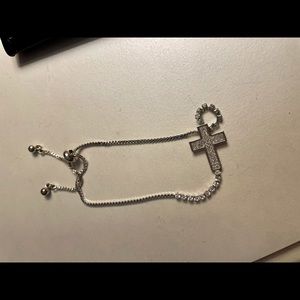 Pull string bracelet with cross